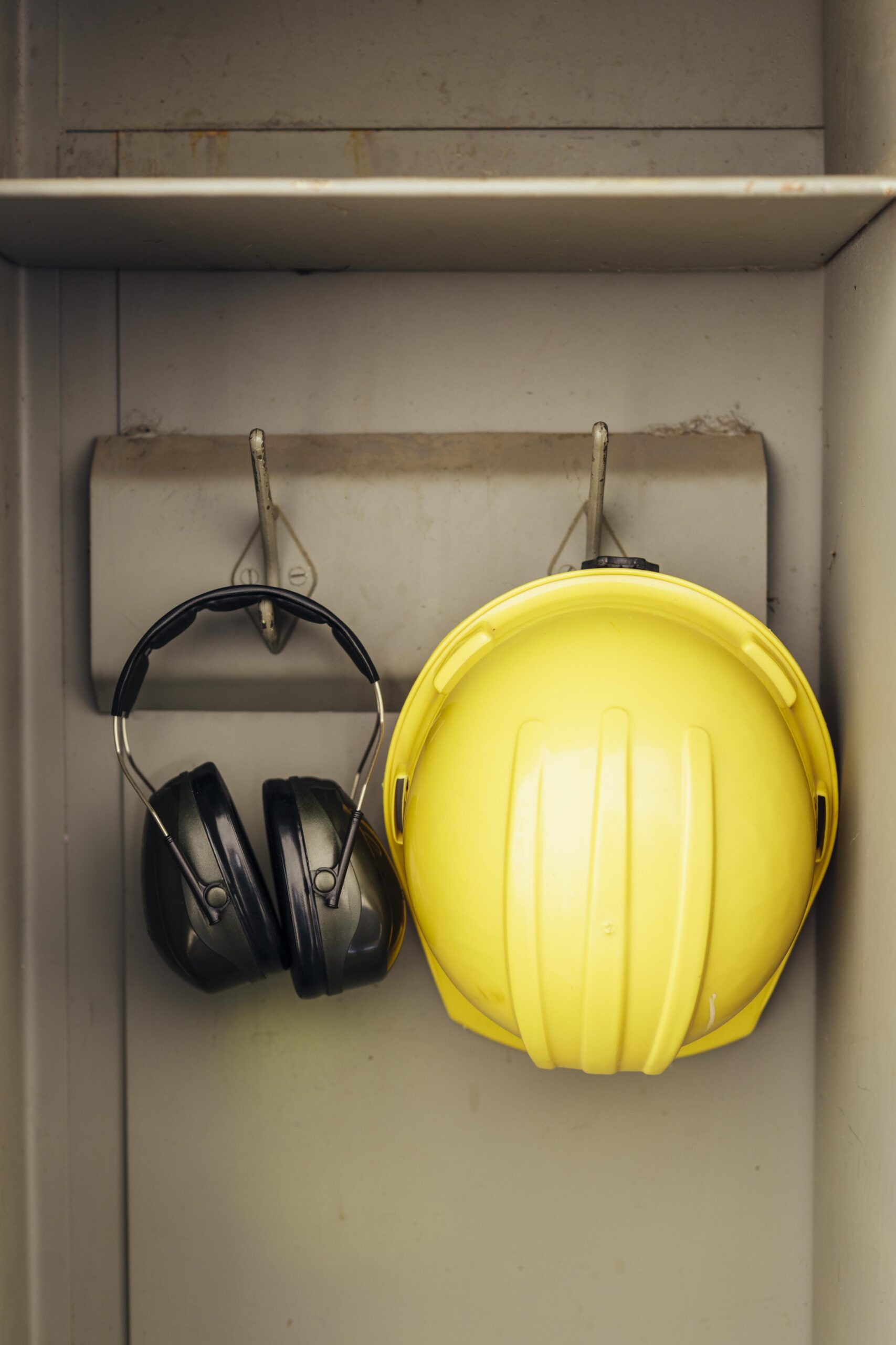 front-view-headphones-hard-hat-hanging-closet